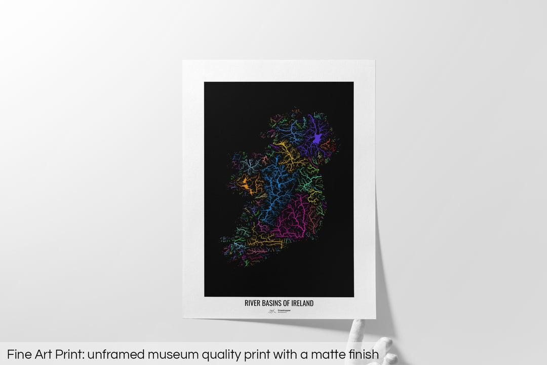 Unframed fine art print of a colourful map with a thick white mat. The title of the map and the Grasshopper Geography logo is printed on the mat, below the image. The map print lies flat on a white surface, a hand holding up one of the corners. The bottom text reads: Fine art print - unframed museum quality print with a matte finish.