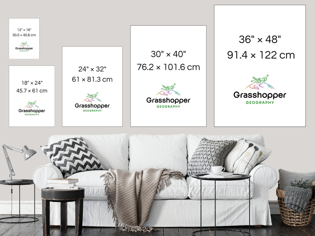 The most popular print sizes Grasshopper Geography maps are available in, lined up above a sofa on a grey wall in a sitting room.