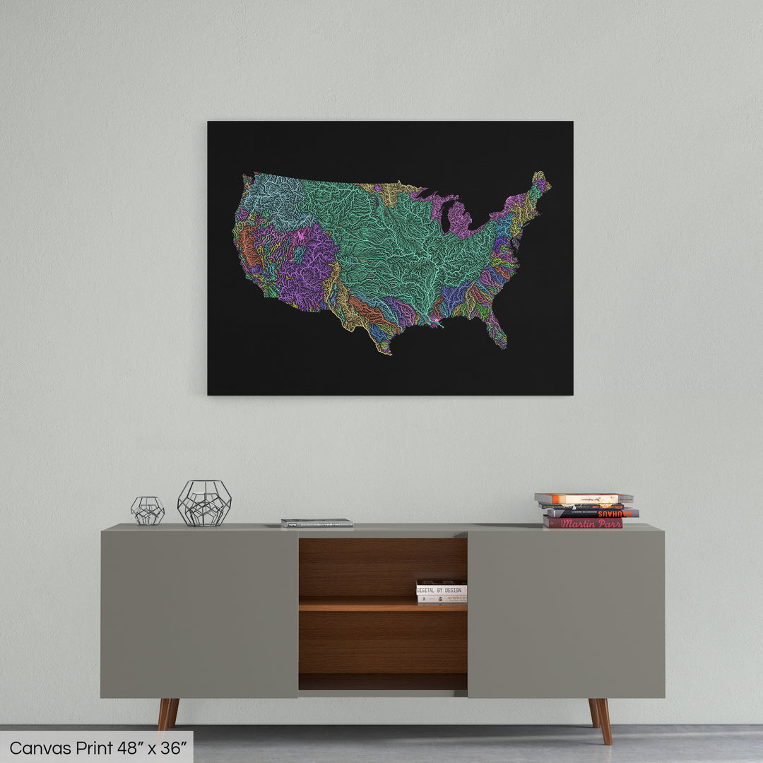 A colourful Grasshopper Geography map home decor in a living room, on a light grey wall. The map is printed on canvas and hangs above a modern low storage cabinet.