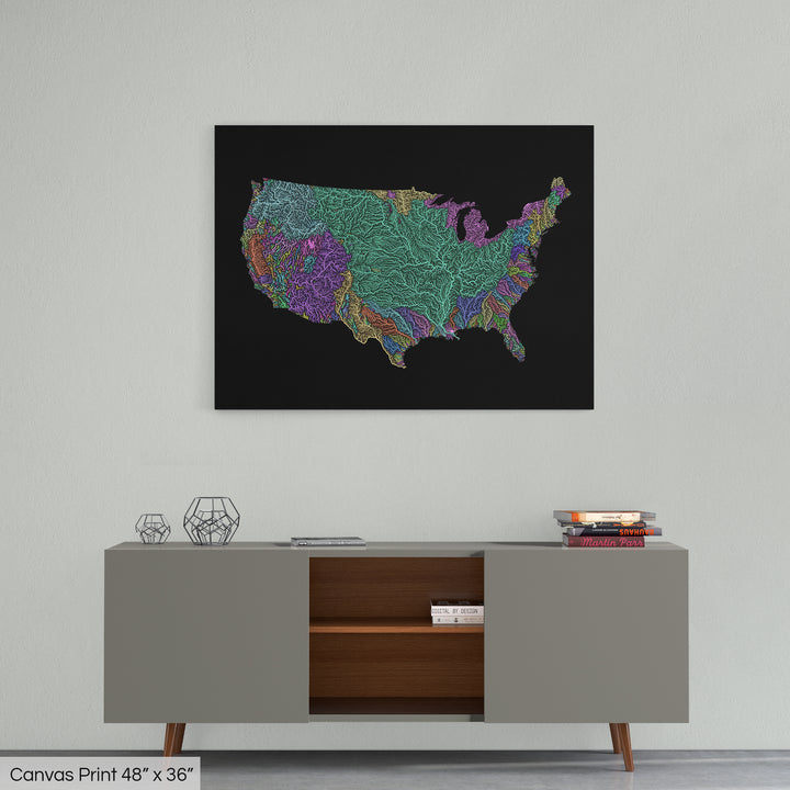 A colourful Grasshopper Geography map home decor in a living room, on a light grey wall. The map is printed on canvas and hangs above a modern low storage cabinet.