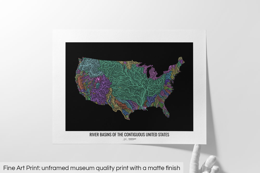 Unframed fine art print of a colourful map with a thick white mat. The title of the map and the Grasshopper Geography logo is printed on the mat, below the image. The map print lies flat on a white surface, a hand holding up one of the corners. The bottom text reads: Fine art print - unframed museum quality print with a matte finish.