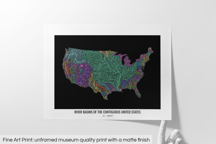 Unframed fine art print of a colourful map with a thick white mat. The title of the map and the Grasshopper Geography logo is printed on the mat, below the image. The map print lies flat on a white surface, a hand holding up one of the corners. The bottom text reads: Fine art print - unframed museum quality print with a matte finish.