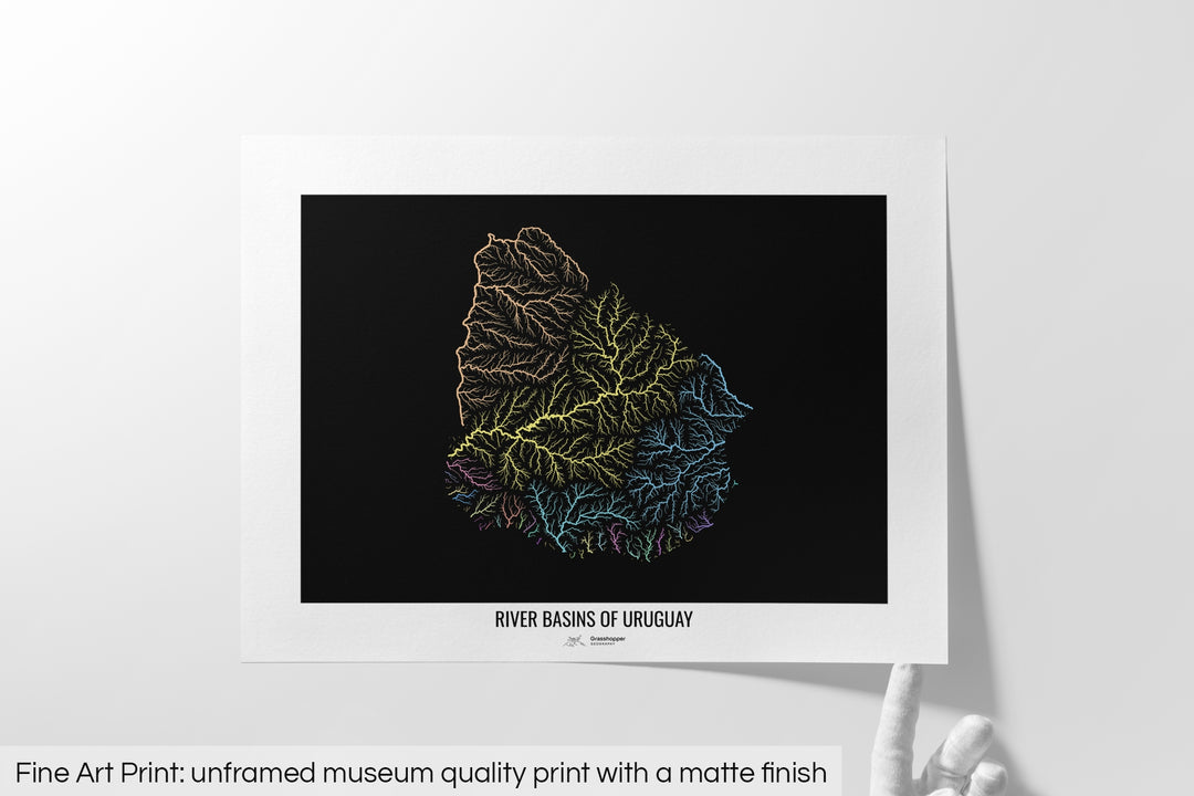 Unframed fine art print of a colourful map with a thick white mat. The title of the map and the Grasshopper Geography logo is printed on the mat, below the image. The map print lies flat on a white surface, a hand holding up one of the corners. The bottom text reads: Fine art print - unframed museum quality print with a matte finish.