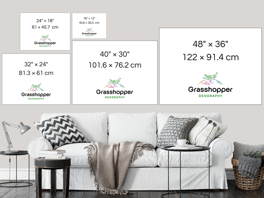 The most popular print sizes Grasshopper Geography maps are available in, lined up above a sofa on a grey wall in a sitting room.