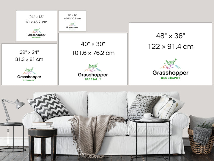 The most popular print sizes Grasshopper Geography maps are available in, lined up above a sofa on a grey wall in a sitting room.