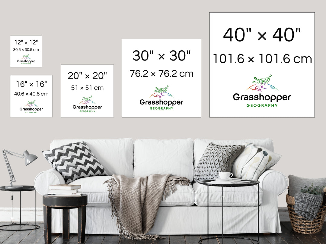 The most popular print sizes Grasshopper Geography maps are available in, lined up above a sofa on a grey wall in a sitting room.