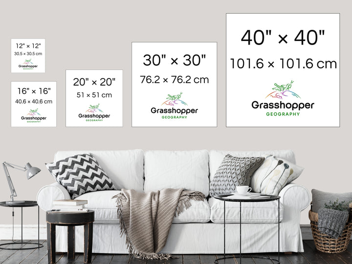 The most popular print sizes Grasshopper Geography maps are available in, lined up above a sofa on a grey wall in a sitting room.