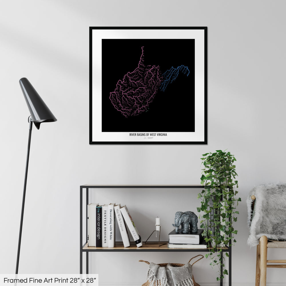 A colourful Grasshopper Geography map on a white wall, home decor in a living room. The map is in a black frame with a thick white mat. The title of the map is printed on the mat. The map hangs above a black shelf with plants and books on. A black lamp stands in the corner.