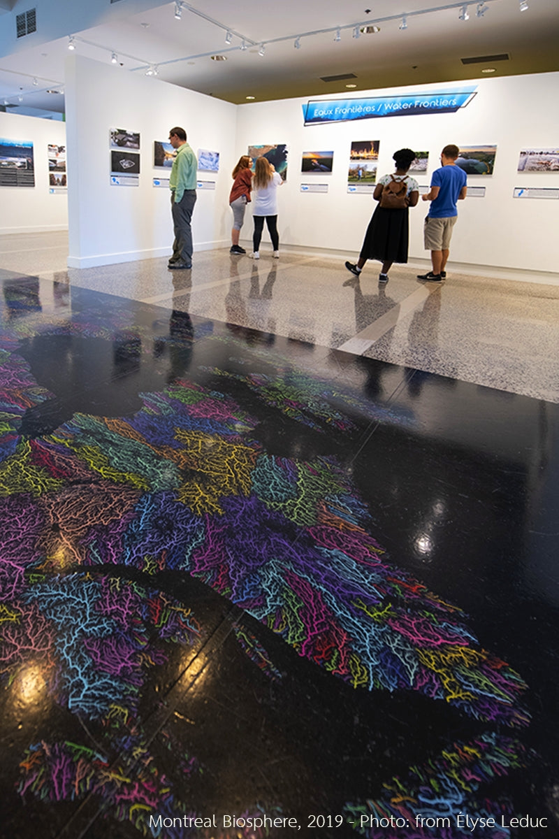 Grasshopper Geography's river basin map of North America printed on the floor of the Montreal Biosphere in 2019, on the exhibition Water Frontiers.